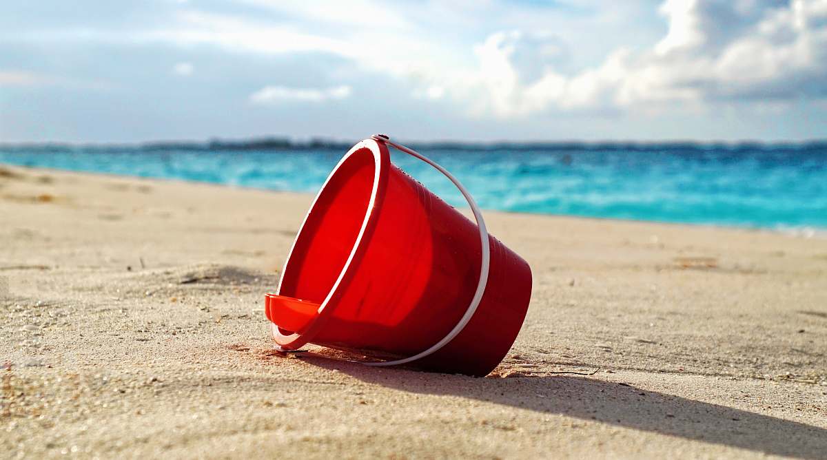 cabbage beach red plastic bucket on seashore paradise island